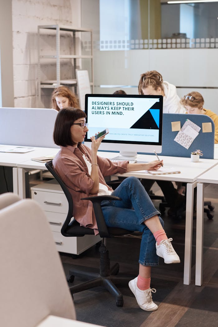 Creative professionals working collaboratively in a modern office space.